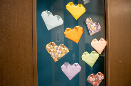 Folded origami hearts on a door